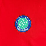 Polo homme rouge 100% coton jersey peau de pêche BACK to LEGEND (zoom badge)