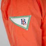 Polo orange à manches longues effet peau de pêche BACK to LEGEND (zoom fanion brodé)