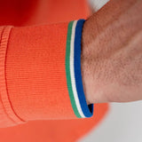 Polo orange à manches longues effet peau de pêche BACK to LEGEND (zoom bord de manche rayé)